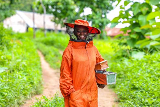 A woman from Nigeria wearing a protective gear for bee farming