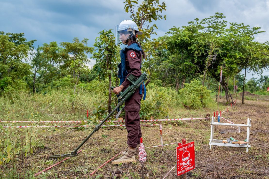 A deminer surveying land for unexploded ordnance in Cambodia