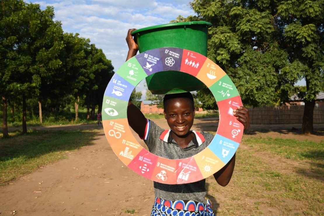 A woman holding the SDG wheel in Malawi