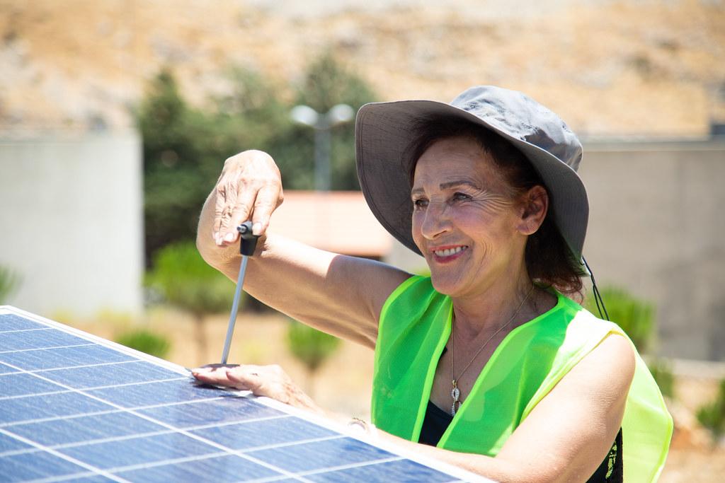 Woman works on solar panel