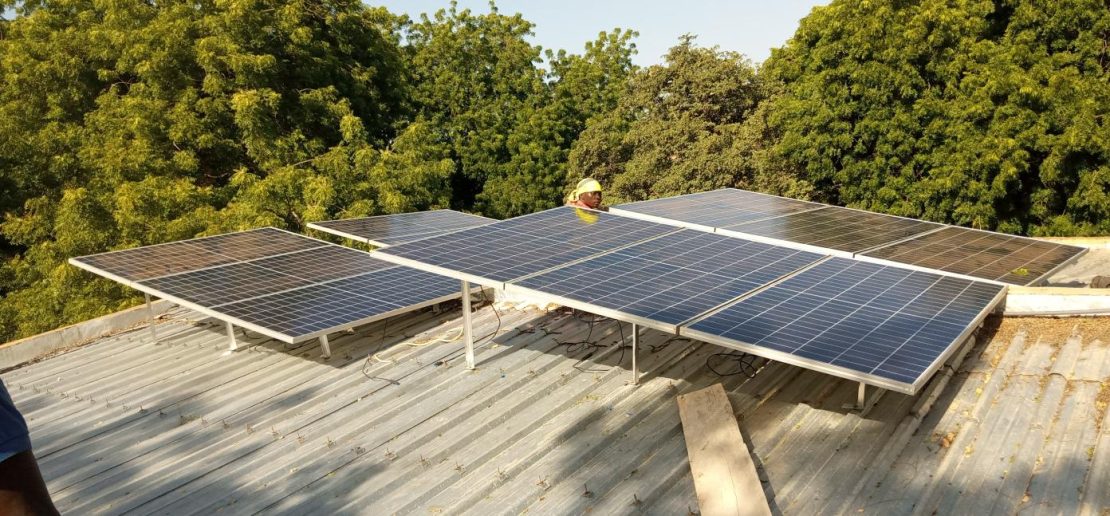 A woman next to a solar panel in Burkina Faso. Photo: UNDP Burkina Faso