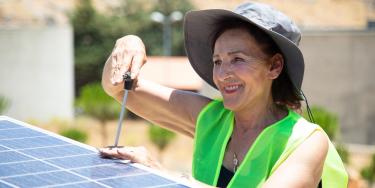 Woman installing solar panel in Lebanon