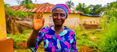 A woman farmer in Sierra Leone standing in her garden