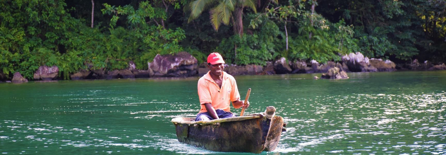 A man on a small boat in Sao Tome and Principe